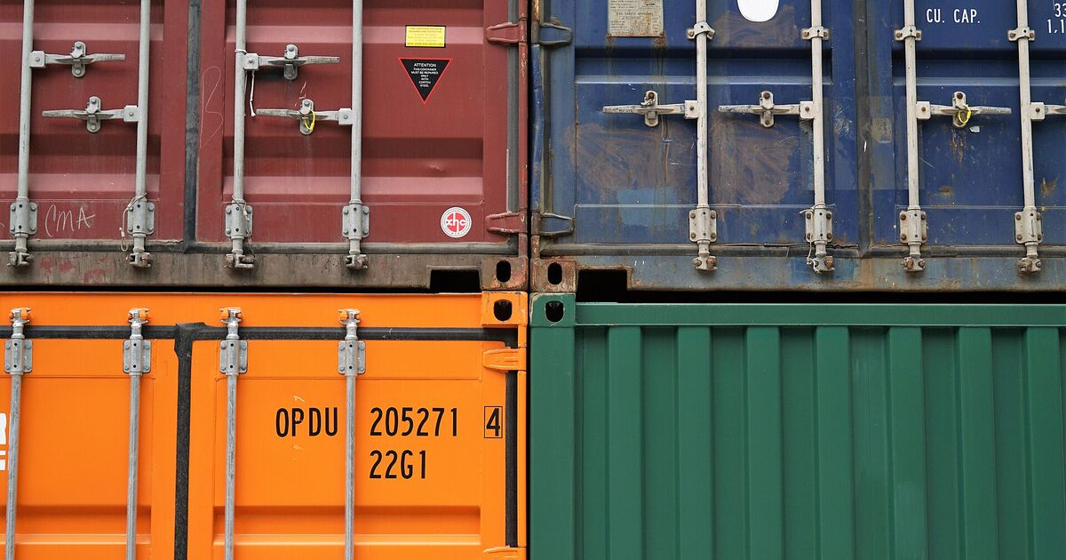 Close-up of shipping container doors showing the container number and weight markings